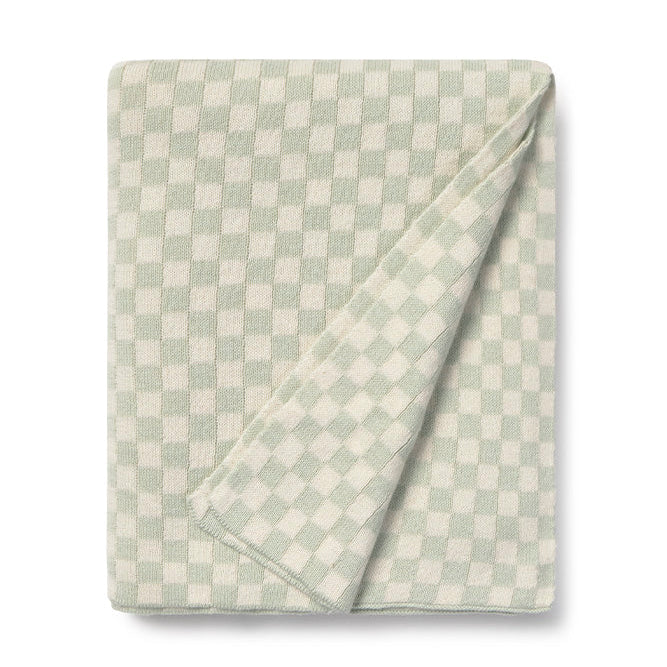 Folded checkered blanket with light blue sage green and white pattern 