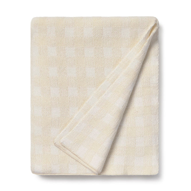 Folded beige and ivory blanket with subtle pattern 