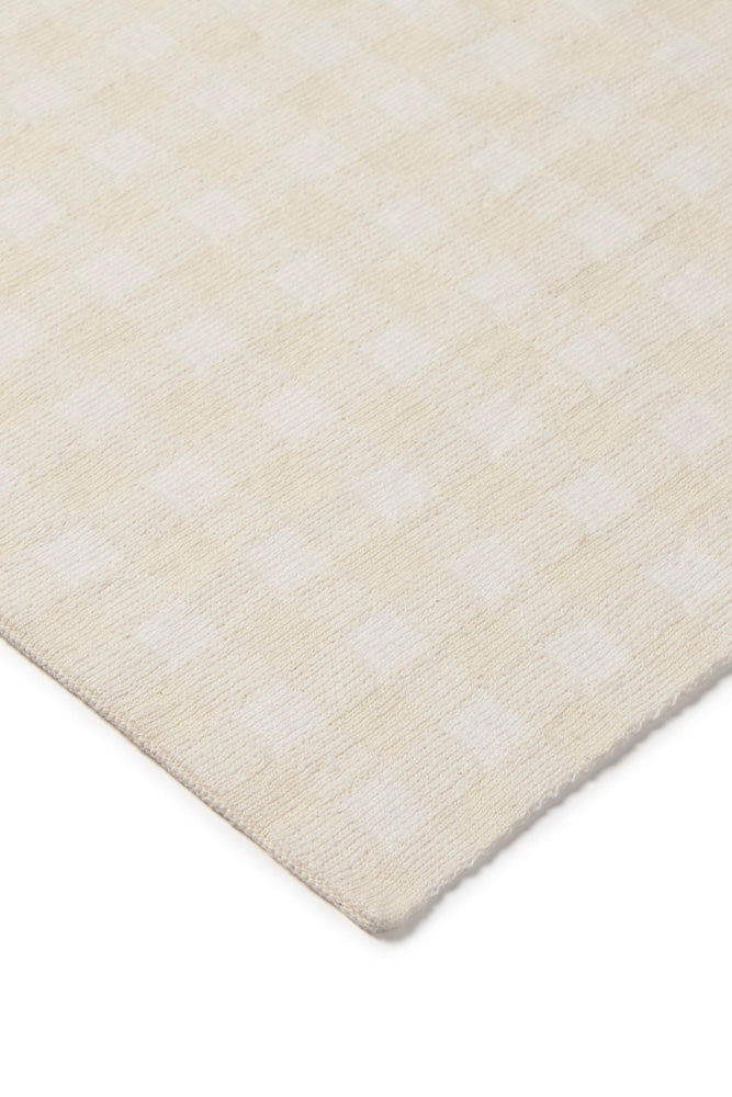 Close-up of an ivory checked blanket with subtle pattern