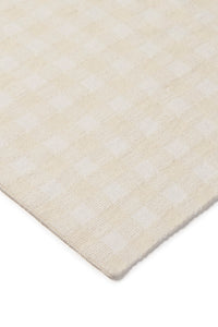 Close-up of an ivory checked blanket with subtle pattern