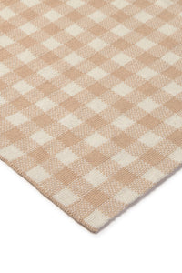 Close-up of a rose and white checkered blanket