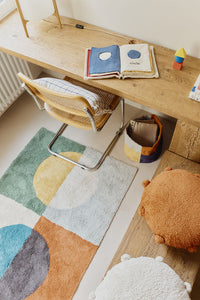 Multicolored geometric rug with circular pattern inspired by Bauhaus