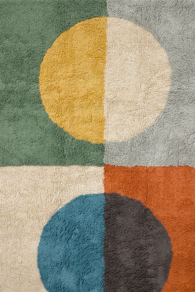 Multicolored geometric rug with circular pattern inspired by Bauhaus