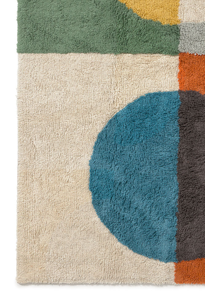 Close up of multicolored geometric rug with circular pattern inspired by Bauhaus