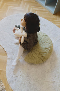 Girl Sitting on Water Lily Floor Cushion on Lake Shaped Rug