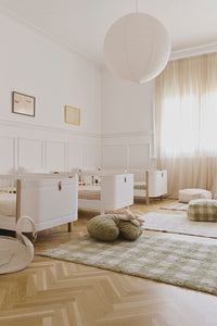Toddler Beds in Room with Checkered Rugs, Blankets and Poufs

