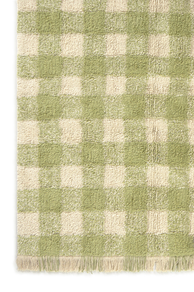 Green and white checkered rug with fringes on a plain background