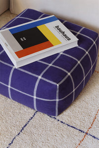 Bauhaus inspired square pouf ottoman with navy blue grid pattern 