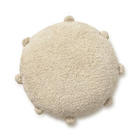 Round natural floor cushion edged with pom-poms