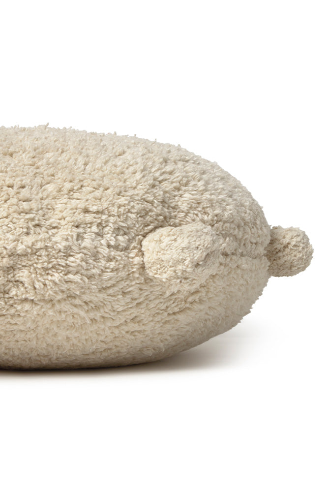 Round natural floor cushion edged with pom-poms