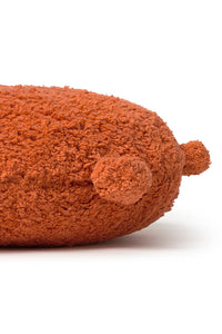 Round orange floor cushion edged with pom-poms