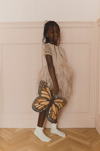 Little Girl Holding Black and Orange Butterfly Pillow