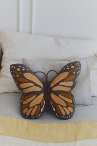 Black and Orange Butterfly Pillow on Bed