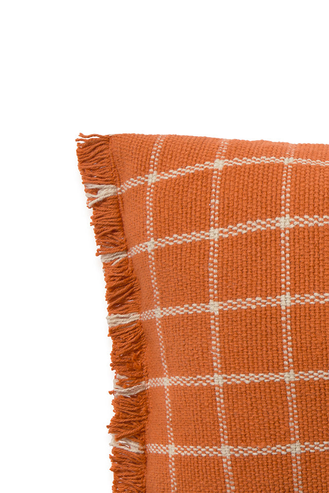 Close up of terracotta orange throw pillow