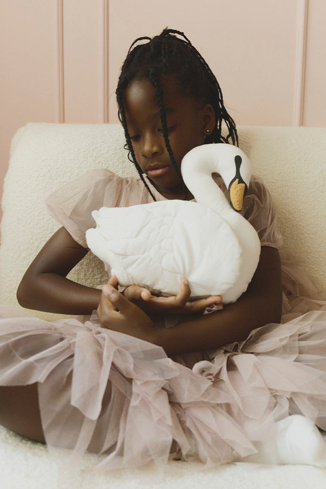 Girl holding swan pillow