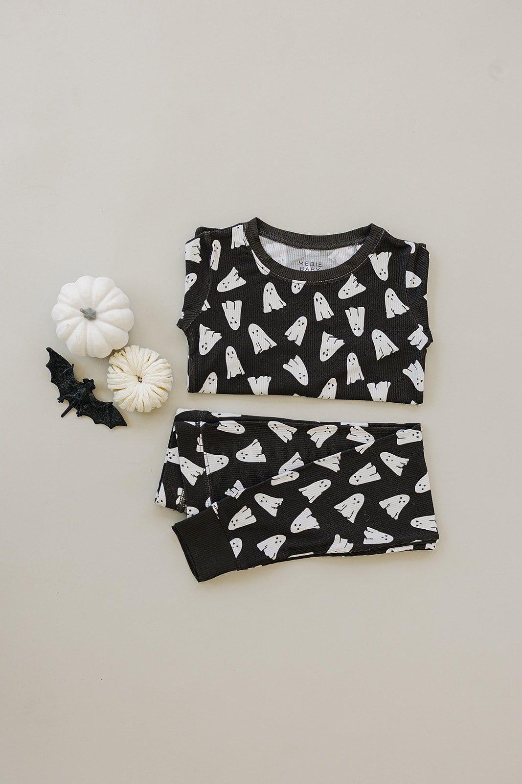 Black pajama set with white ghost pattern on a light gray background
