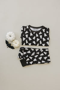 Black pajama set with white ghost pattern on a light gray background