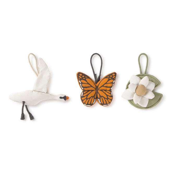 Three baby rattle hangers shaped like a swan, butterfly, and water lily pad 