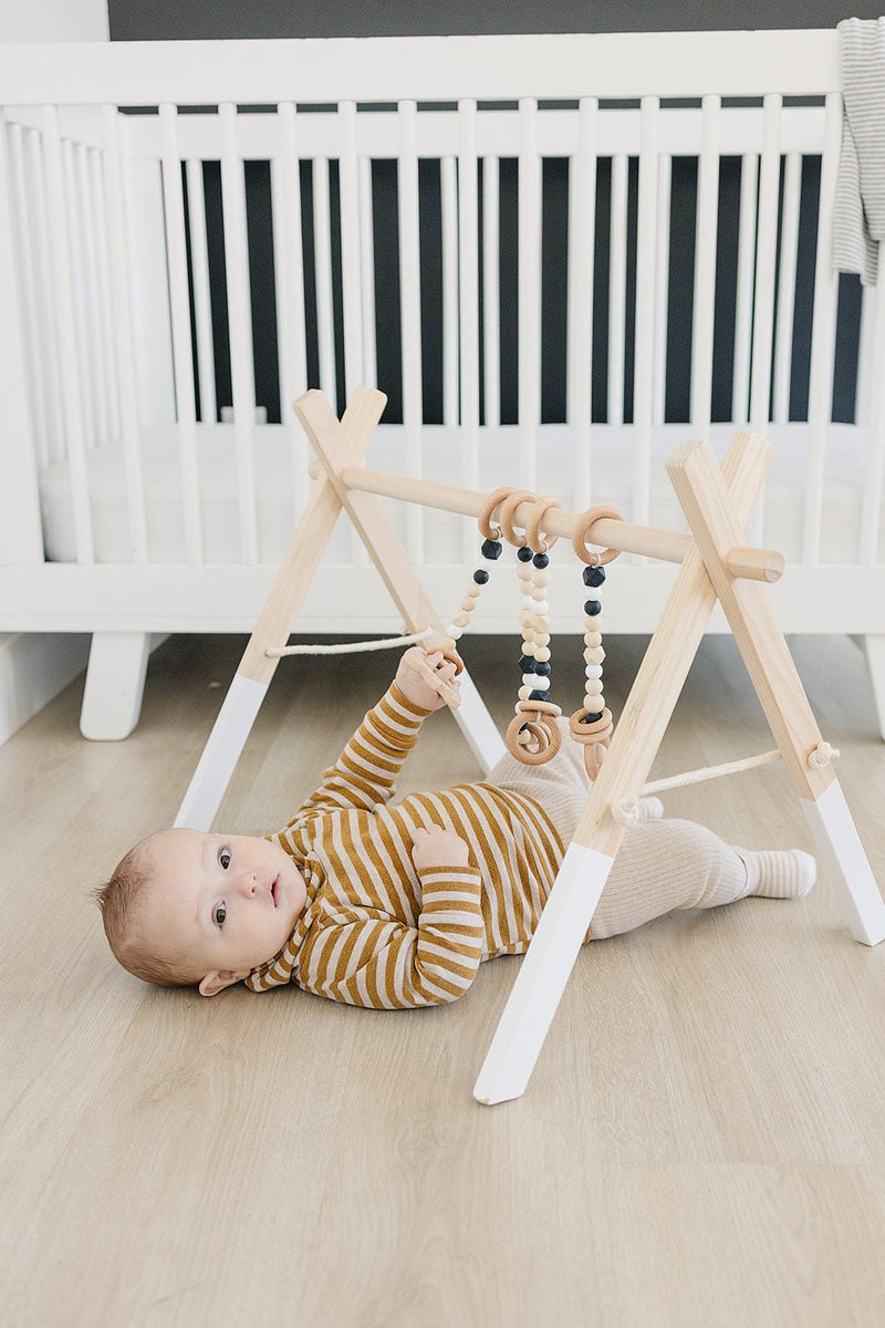 Wooden Baby Play Gym with Black Toys - Project Nursery