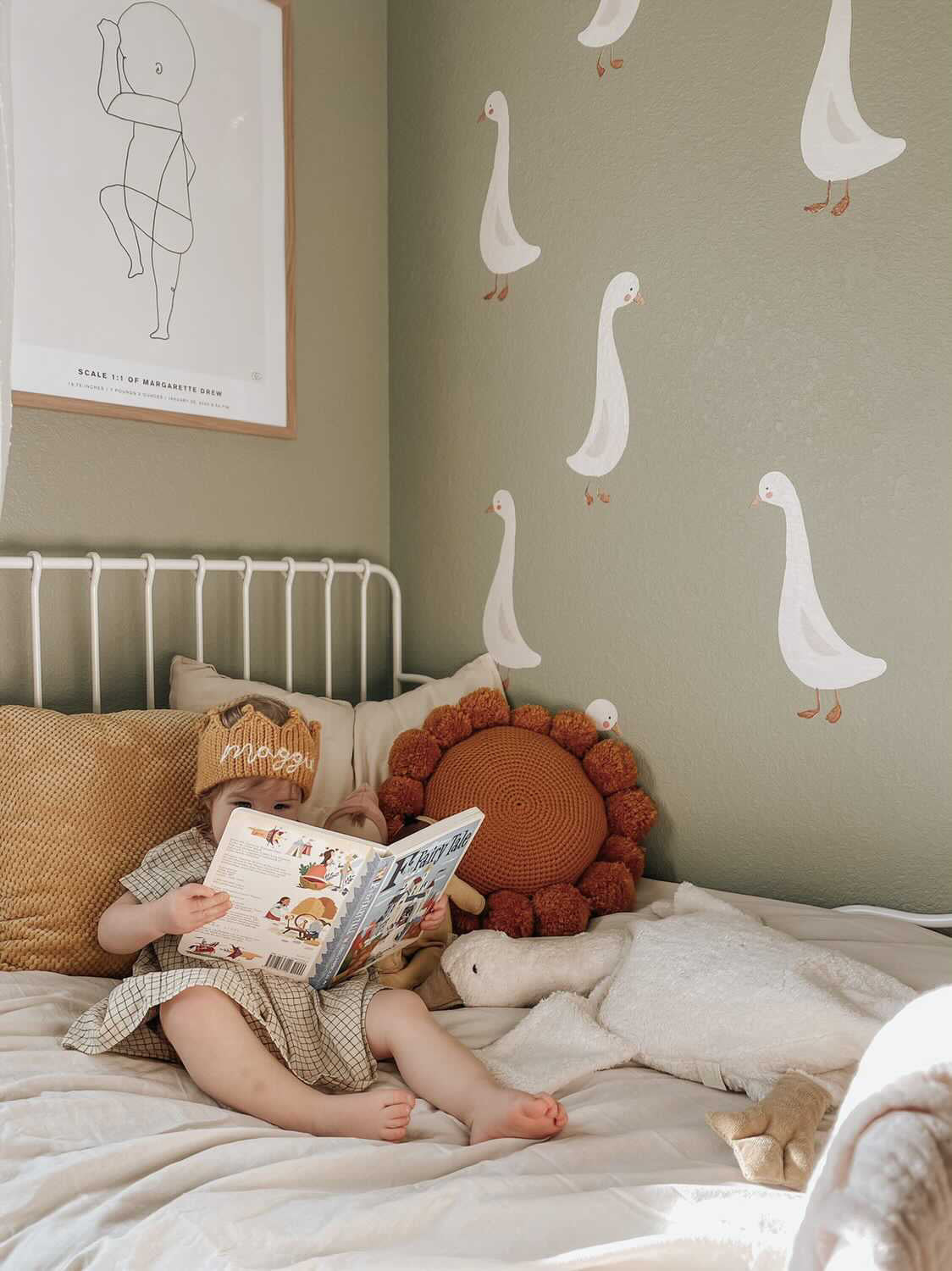 goose decals on green wall, next to kid bed