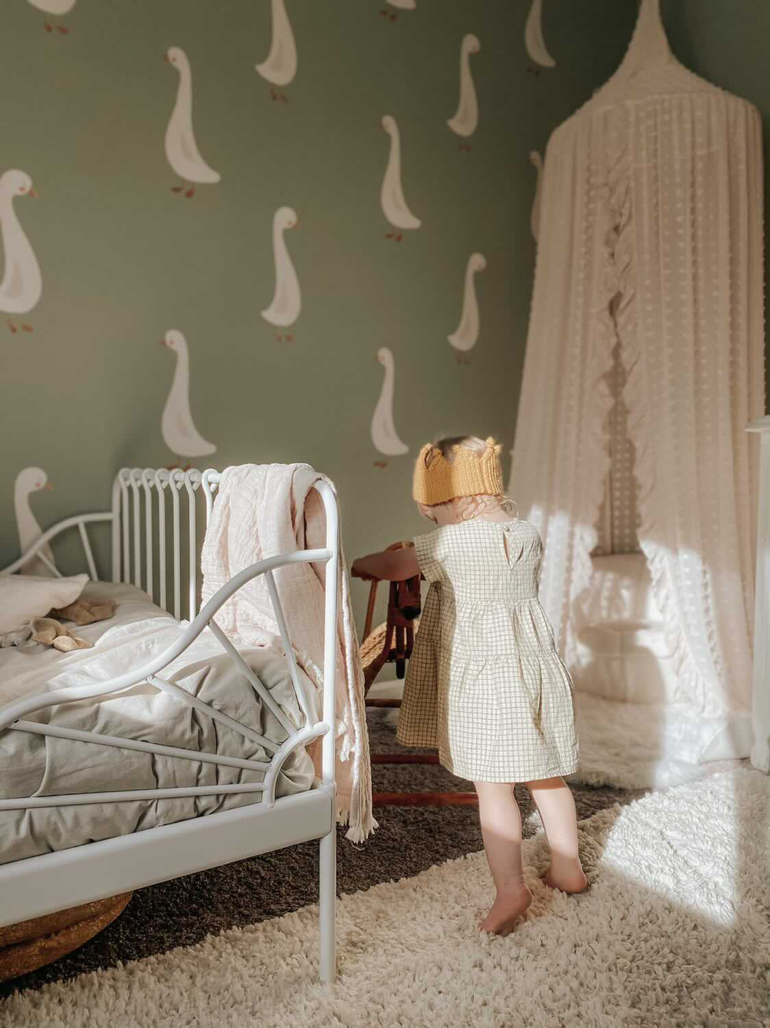 goose decals on a green backdrop next to kids bed
