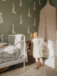 goose decals on a green backdrop next to kids bed
